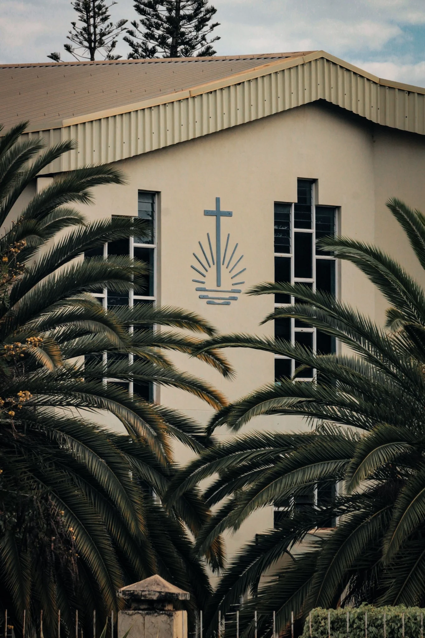 Church building framed by palm trees